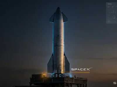 A SpaceX Starship rocket standing idle on its launch pad at dusk with the SpaceX logo and an amber hold indicator