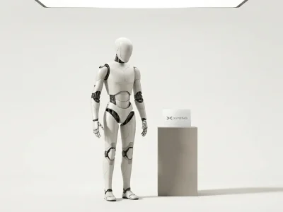 A pearl-white humanoid robot standing on a bone-white studio backdrop next to a grey plinth holding a printed card with the XPENG logo