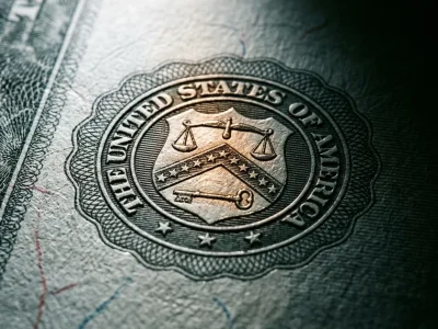 Extreme macro of an engraved United States Treasury bond certificate showing the Department of the Treasury seal in raking light